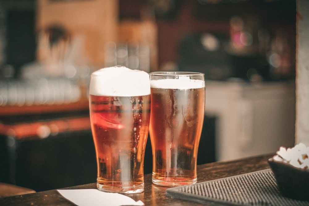 depth of field photo of two pilsner glasses